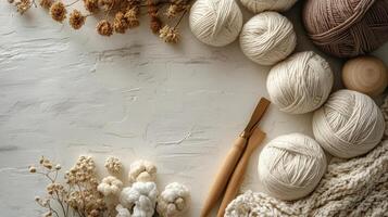 Various yarns and knitting needles on a white table photo