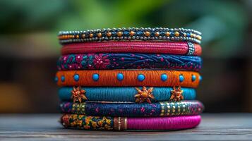A stack of colorful bangles on a wooden table photo