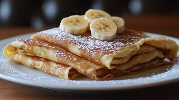 A stack of pancakes with bananas on top photo