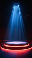 A stage with a spotlight and red and blue lights photo