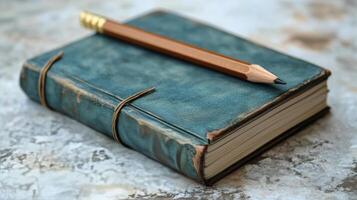 A pencil and an old book on a table photo
