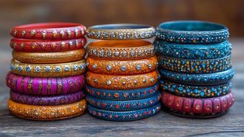 A stack of colorful bangles on a wooden table photo