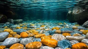 Colorful stones under clear water showcasing vibrant textures and reflections in a serene environment photo