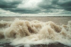 A large wave crashing into the water photo