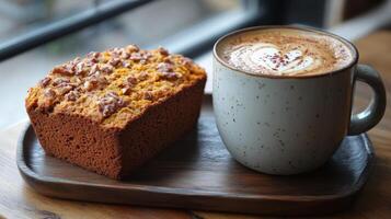 A cup of coffee and a piece of cake on a tray photo