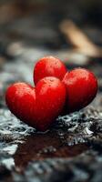 Two red hearts sitting on a wet surface photo