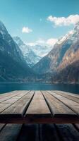A wooden deck overlooking a lake and mountains photo