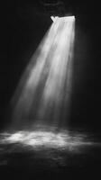 A black and white photo of a light shining through a door