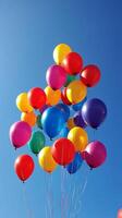 A bunch of balloons floating in the air photo