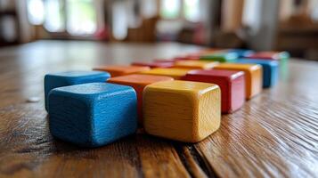 Colorful wooden blocks on a wooden table photo