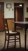 A chair sits in front of a table in a room photo
