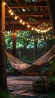 A hammock under a pergola with string lights photo