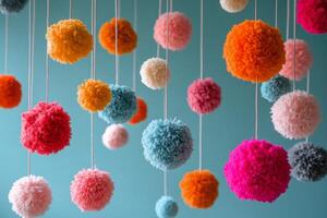 Pom pom decorations hanging from strings photo