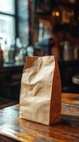 A brown paper bag sitting on top of a wooden table photo