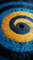 A blue and yellow spiral on the ground photo