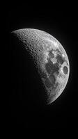 Moon phase over a lunar landscape captured in detailed black and white photo