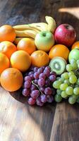 Fresh assorted fruits arranged on a wooden table with vibrant colors and textures photo