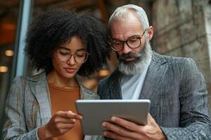 Diverse professionals review data together in a modern office setting during the day photo