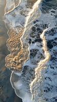 Aerial view of waves crashing on the beach photo