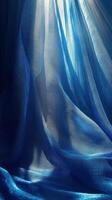 A blue curtain with light coming through it photo