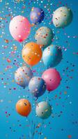 Many balloons are floating in the air with confetti photo