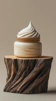 A jar of cream sitting on top of a wooden stump photo