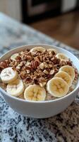 A bowl of oatmeal with bananas and pecans photo