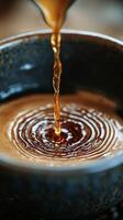 A spoon pouring liquid into a bowl of coffee photo