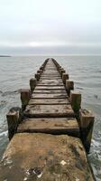 A wooden pier stretching out into the ocean photo