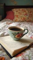 Warm coffee in a cup placed on an open notebook beside a cozy window photo