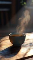 A bowl of steaming hot soup on a table photo