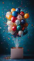 A box with balloons and confetti on a blue background photo
