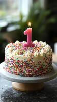 A cake with a one candle on it photo