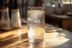 A glass of water sitting on a table photo