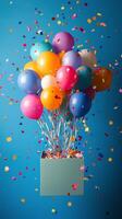 A box filled with balloons and confetti on a blue background photo