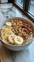 A bowl of cereal with bananas and almonds photo