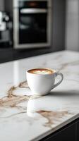 A coffee cup sitting on a marble counter top photo
