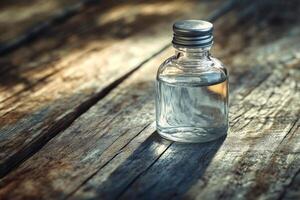 A small bottle of perfume sitting on a wooden table photo