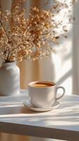 Coffee cup on a table with flowers photo