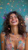 A woman is laughing and throwing confetti photo