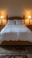 A bed with a white comforter photo