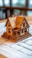 A model of a house sitting on top of a blueprint photo