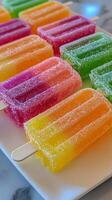 A white plate with a bunch of colorful popsicles photo
