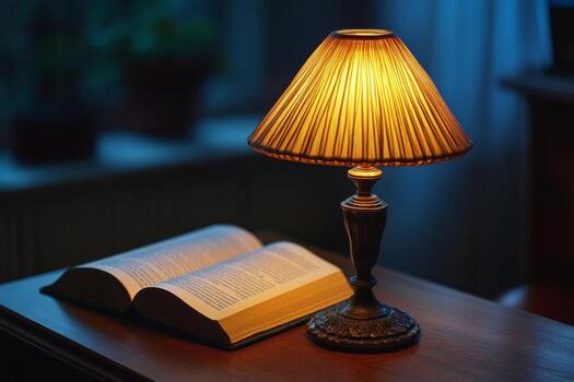 A lamp and an open book on a table photo