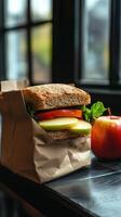 A sandwich sitting on a paper bag photo