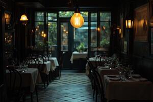 A dimly lit restaurant with tables and chairs photo
