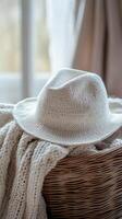 A white hat sits on top of a basket photo