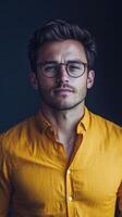 A man in glasses and a yellow shirt photo