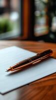 Pen and paper on wooden table photo