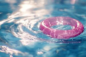 A pink ring floating in a pool of water photo